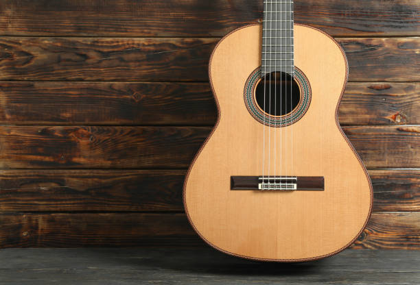 istock Beautiful six - string classic guitar against wooden background, space for text 1147314689