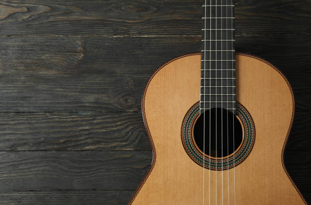 istock Beautiful six - string classic guitar on wooden background, space for text 1147314964