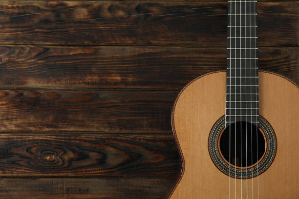 istock Beautiful six - string classic guitar on wooden background, space for text 1147315069