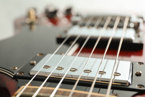 istock Beautiful six - string electric guitar on white background, closeup 1147315162