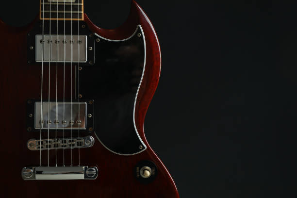 istock Beautiful six - string electric guitar against dark background, space for text 1147315199