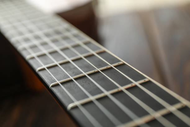 istock Guitar neck against wooden background, space for text 1147315215