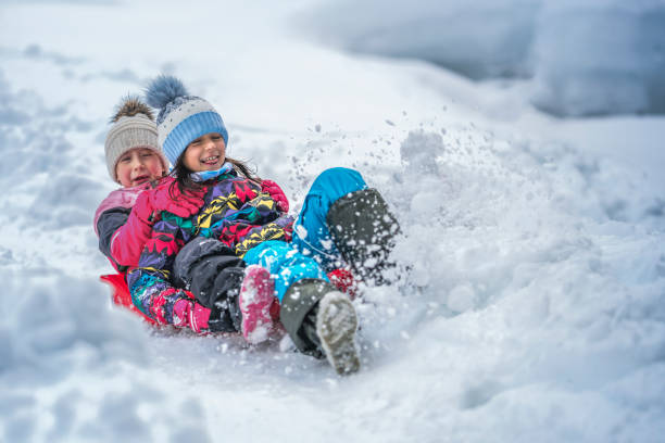 istock Girls sliding on snow 1147315456