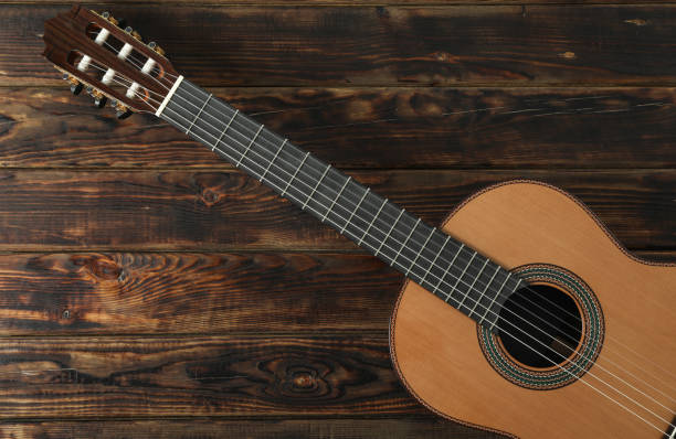 istock Beautiful six - string classic guitar on wooden background, space for text 1147315485