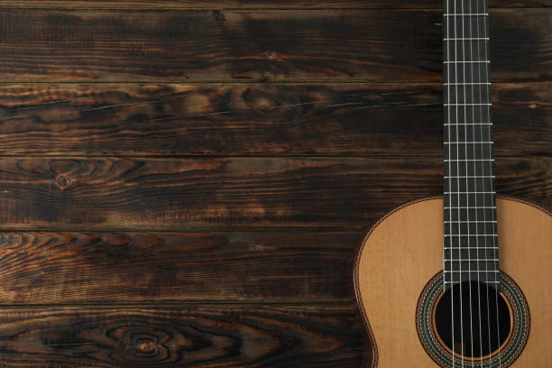 istock Beautiful six - string classic guitar on wooden background, space for text 1147315500