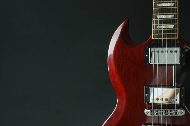 istock Beautiful six - string electric guitar against dark background, space for text 1147315623