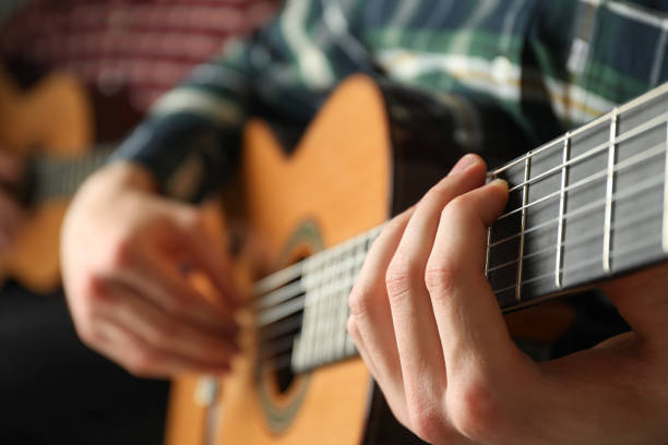istock Two guitar players with classic guitars, space for text 1147316212