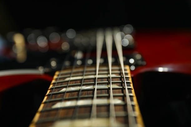 istock Beautiful six - string electric guitar against dark background, closeup 1147316279