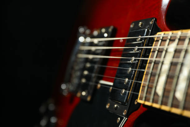 istock Beautiful six - string electric guitar against dark background, closeup 1147316401