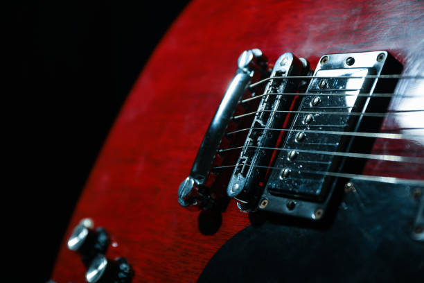 istock Beautiful six - string electric guitar against dark background, closeup 1147316408