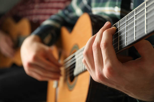 istock Two guitar players with classic guitars, space for text 1147316470