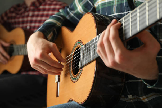 istock Two guitar players with classic guitars, space for text 1147316478