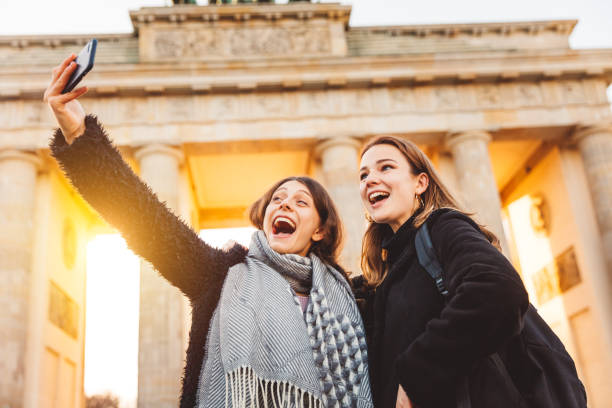 istock Two Friends at Brandeburg Gate in Berlin take a selfie 1147316888