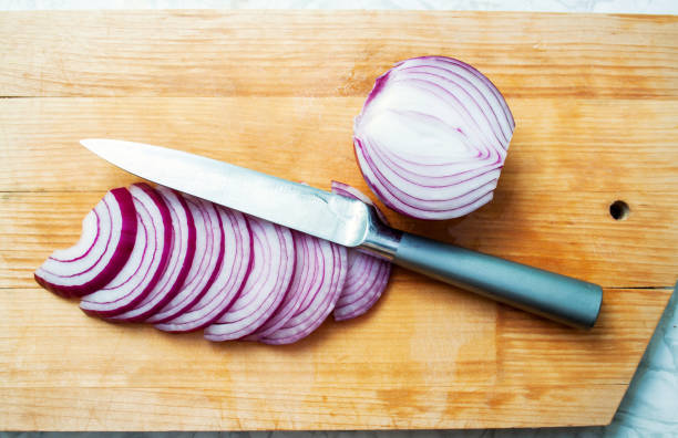 istock sliced red onion and knife on a wooden board 1147317100
