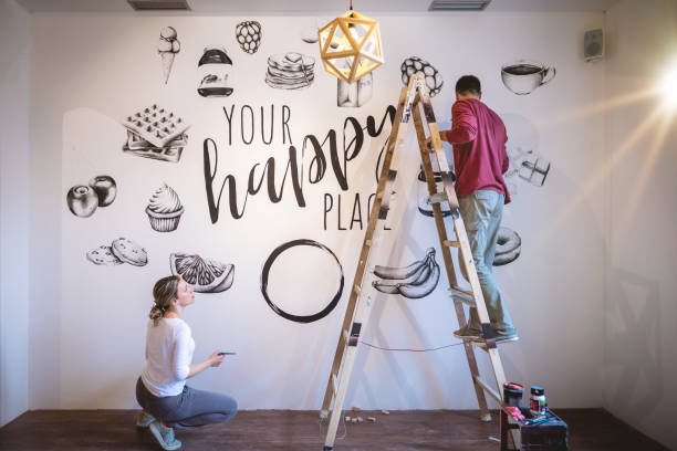 istock Two handsome artists help each-other complete their biggest mural by far 1147317107