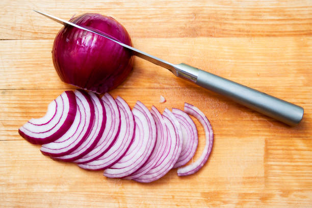 istock red onion and knife on a wooden board 1147317141