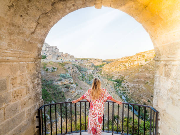 young blonde girl looking out over the  landscape of the sassi di matera - matera imagens e fotografias de stock