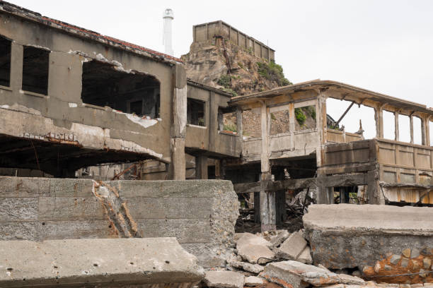 Ruins in Hashima Island, Japan Hashima Island, Japan - 11 April 2019: Hashima Island-Gunkanjima meaning Battleship Island, is an abandoned island lying about 15 kilometers (9 miles) from the city of Nagasaki, in southern Japan. This is former coal mining island. It is old coal mine in Japan closed at 1974 due to the closure of coal mine. sites of japans meiji industrial revolution photos stock pictures, royalty-free photos & images