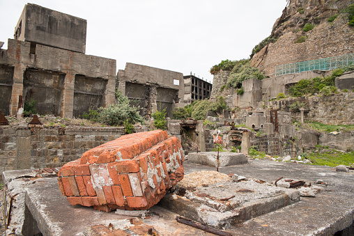 Hashima Island, Japan - 11 April 2019: Hashima Island-Gunkanjima meaning Battleship Island, is an abandoned island lying about 15 kilometers (9 miles) from the city of Nagasaki, in southern Japan. This is former coal mining island. It is old coal mine in Japan closed at 1974 due to the closure of coal mine.