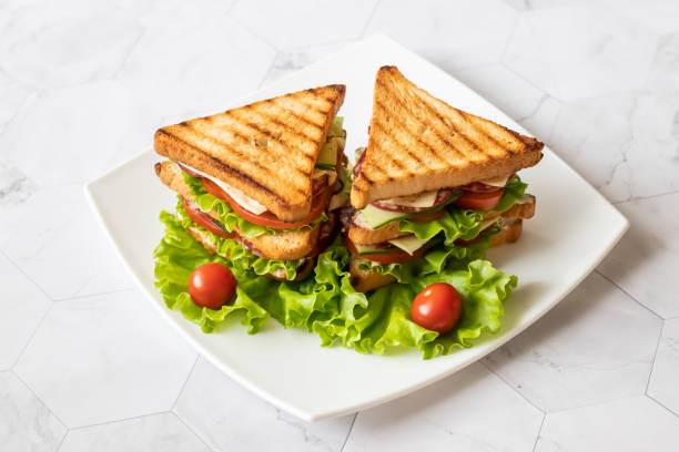 istock Sandwich with cheese, tomato, cucumber, sausage and salad on a light background. . Horizontal orientation 1147321591
