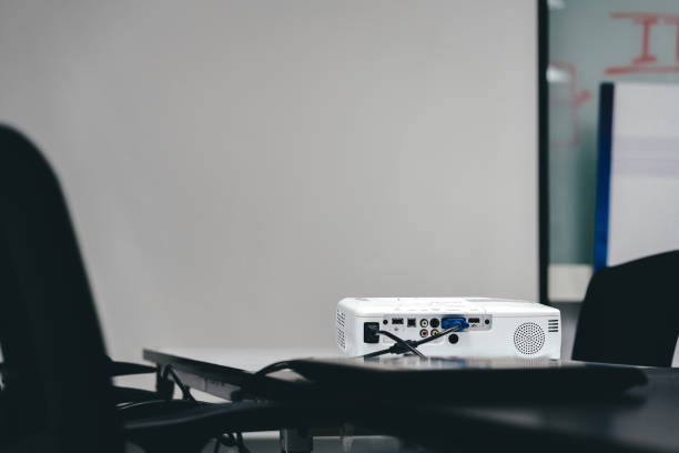 istock white projector on black table for business presentation in the meeting room. 1147321870