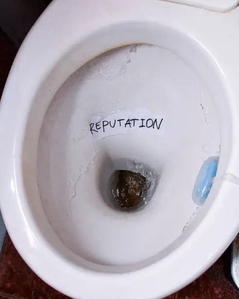 Photo of Reputation note in the toilet ready to be flushed