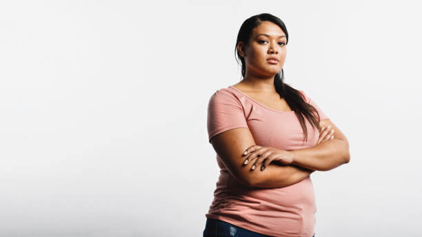 istock Woman standing with arms crossed 1147322071