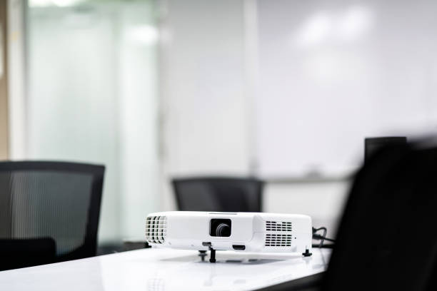 istock white projector on write table for business presentation in the meeting room. 1147323375