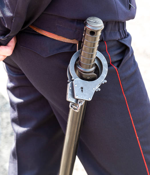 istock Russian policeman with truncheon and handcuffs 1147323526