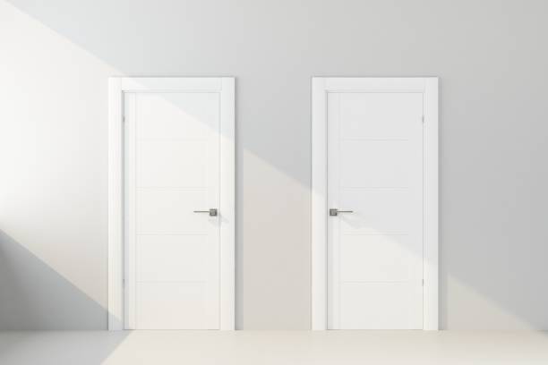 two white door in white wall stock photo