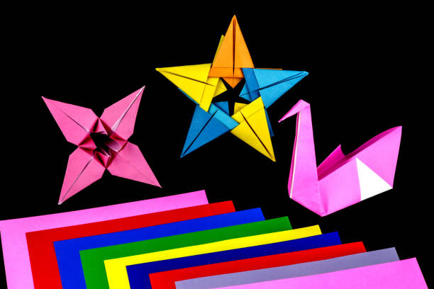 istock Origami Models and Coloured Paper on a Black Background 1147324347