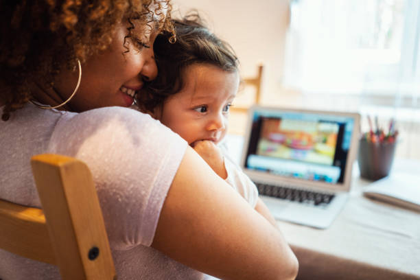 istock Mother and daughter using laptop at home 1147324791