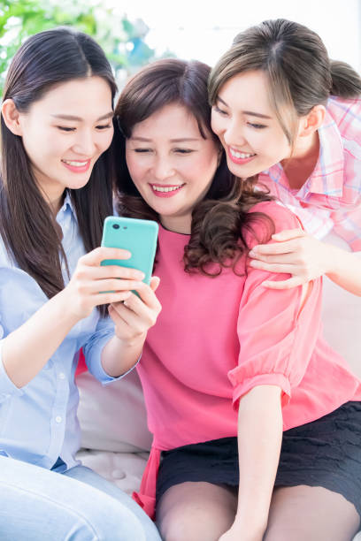 istock Daughters and mother use smartphone 1147326582