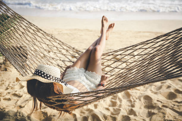 istock Happy woman relaxing in hammock 1147327309