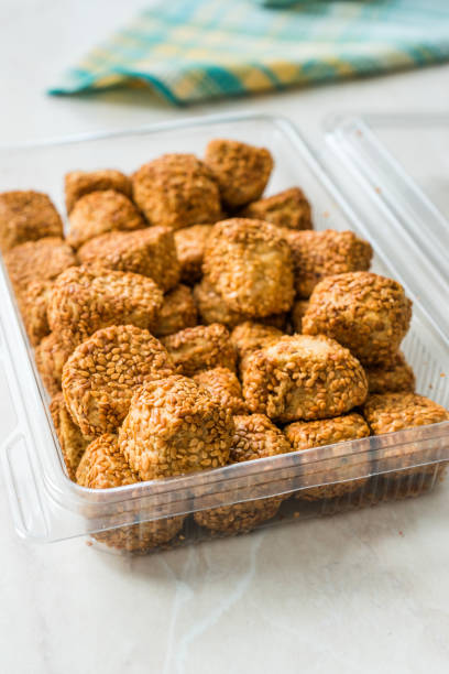 istock Turkish Salty Bakery Bagel Balls Kahke Simit with Sesame Seeds / Salted Snacks in Plastic Cup Package or Container. 1147330164