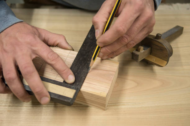 istock a joiner with a pencil and a square marks the workpiece 1147331417