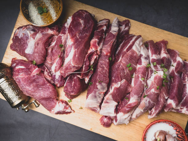 istock fresh pork with ingredients for cooking on dark background 1147332500
