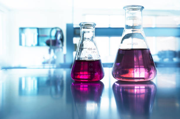 istock two glass flask with pink solution in chemistry science blue laboratory background 1147334536