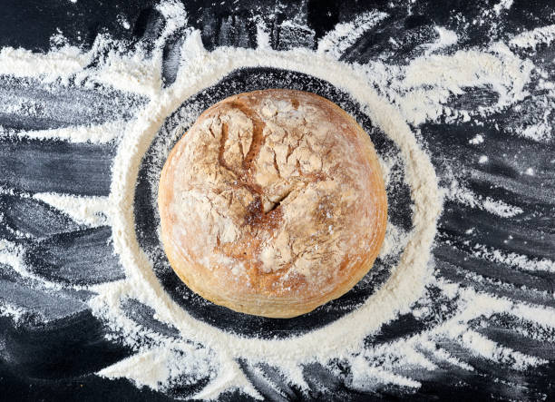 istock round baked bread and white wheat flour scattered 1147334874