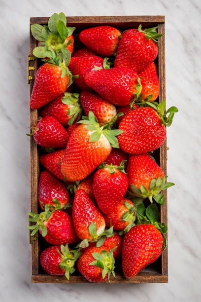 istock Wooden box with market fresh strawberries 1147335708