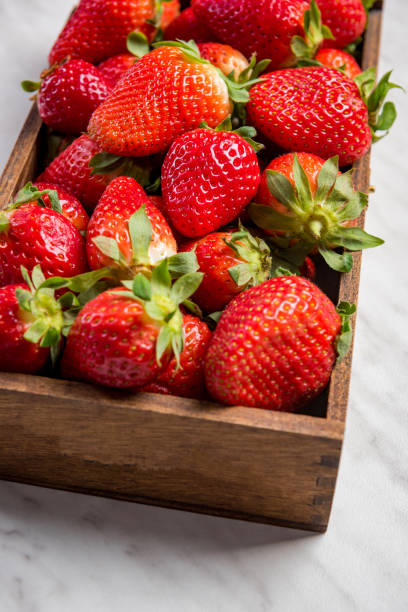 istock Wooden box with market fresh strawberries 1147335909