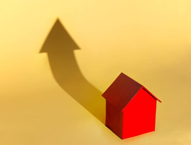 istock Red House Casting Shadow of Arrow 1147337714