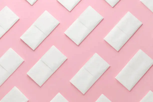 paper tissue abstract pattern on pink background, flatlay