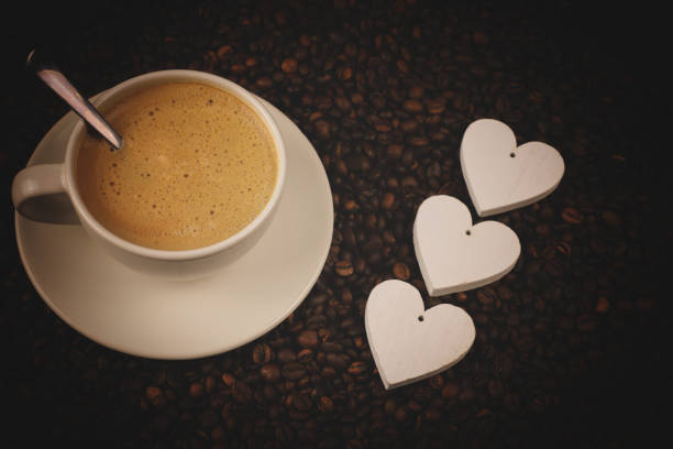 istock Coffee cup with beans, hearts and shine 1147338115