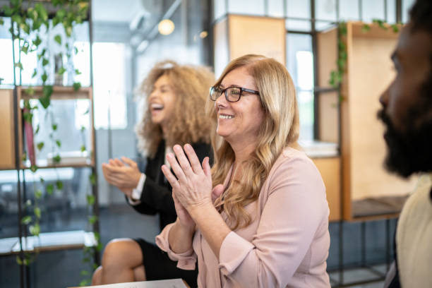 istock Group of business people clapping hands during seminar 1147338197