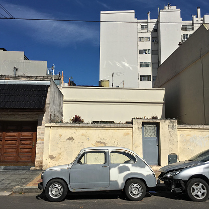 Buenos Aires, Argentina - April 6, 2019: Old Fiat model 600 in the process of renovation parked in the street. The auto repair shops don't have enough space in there places so they keep the cars outdoors