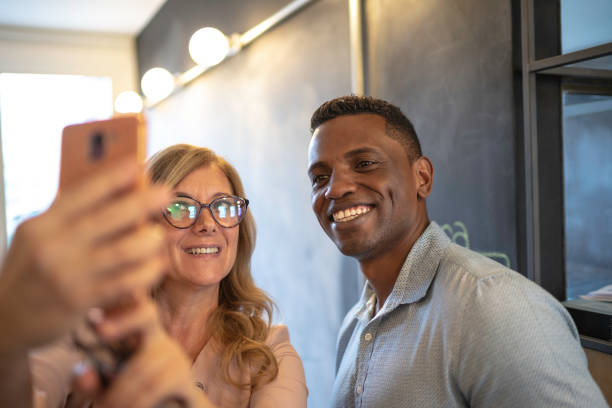 istock Friends Coworkers Taking a Selfie at Work 1147340849