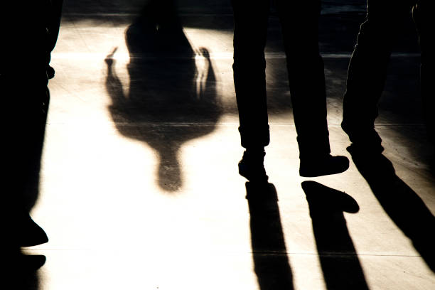 istock Shadow silhouettes of people walking 1147341863
