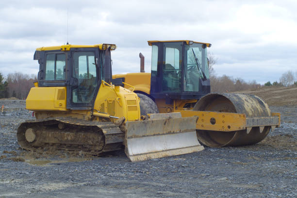 istock paving construction site bulldoser steamroller asphalting industry 1147342161