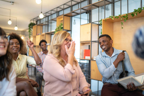 istock Audience laughing at business convention and presentation 1147342331